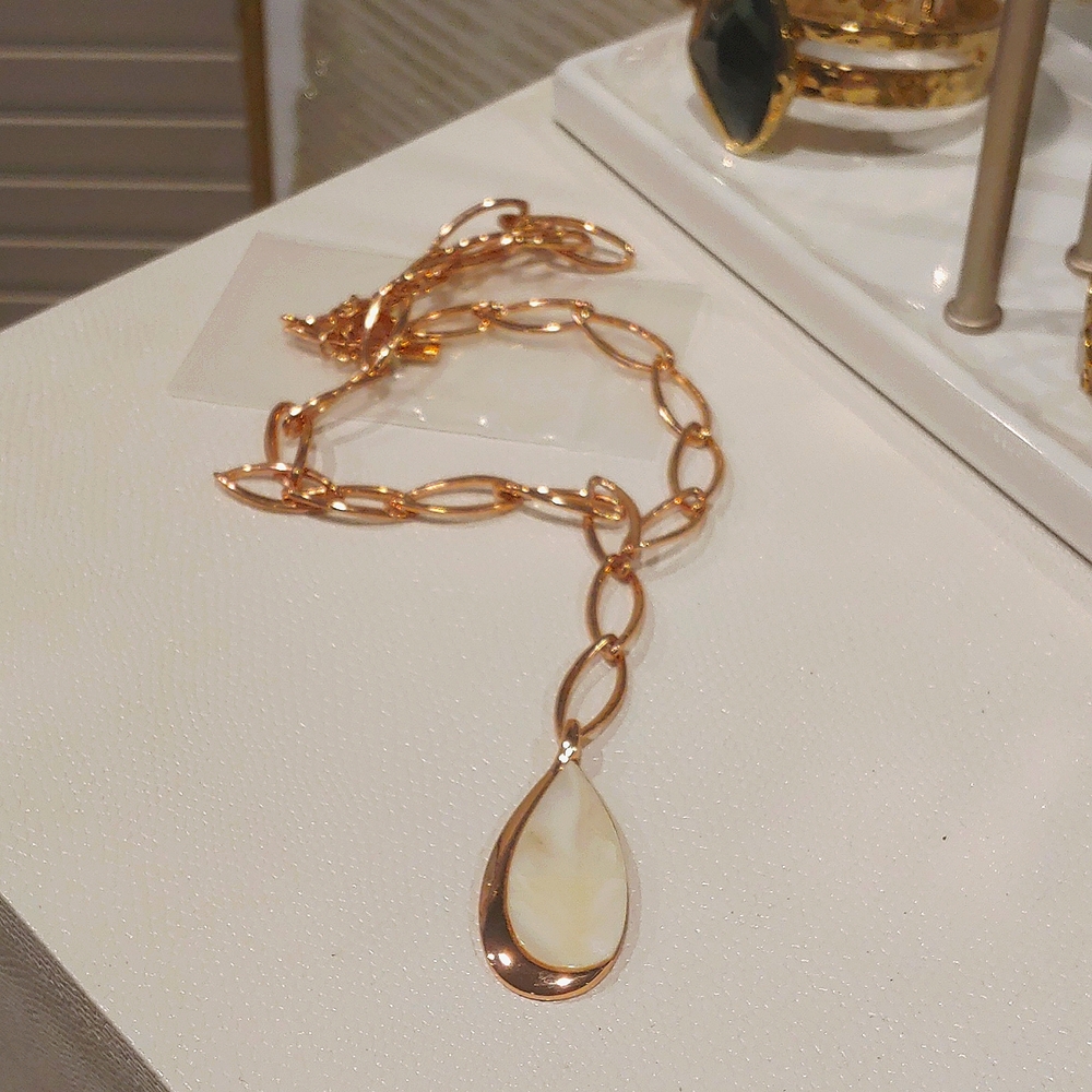 Rose gold link necklace with mother of pearl drop accent.